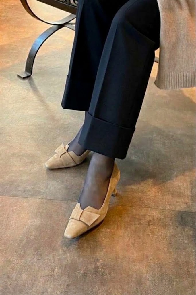 Women's sand bow pumps with almond toe and mid spool heel - Worn view